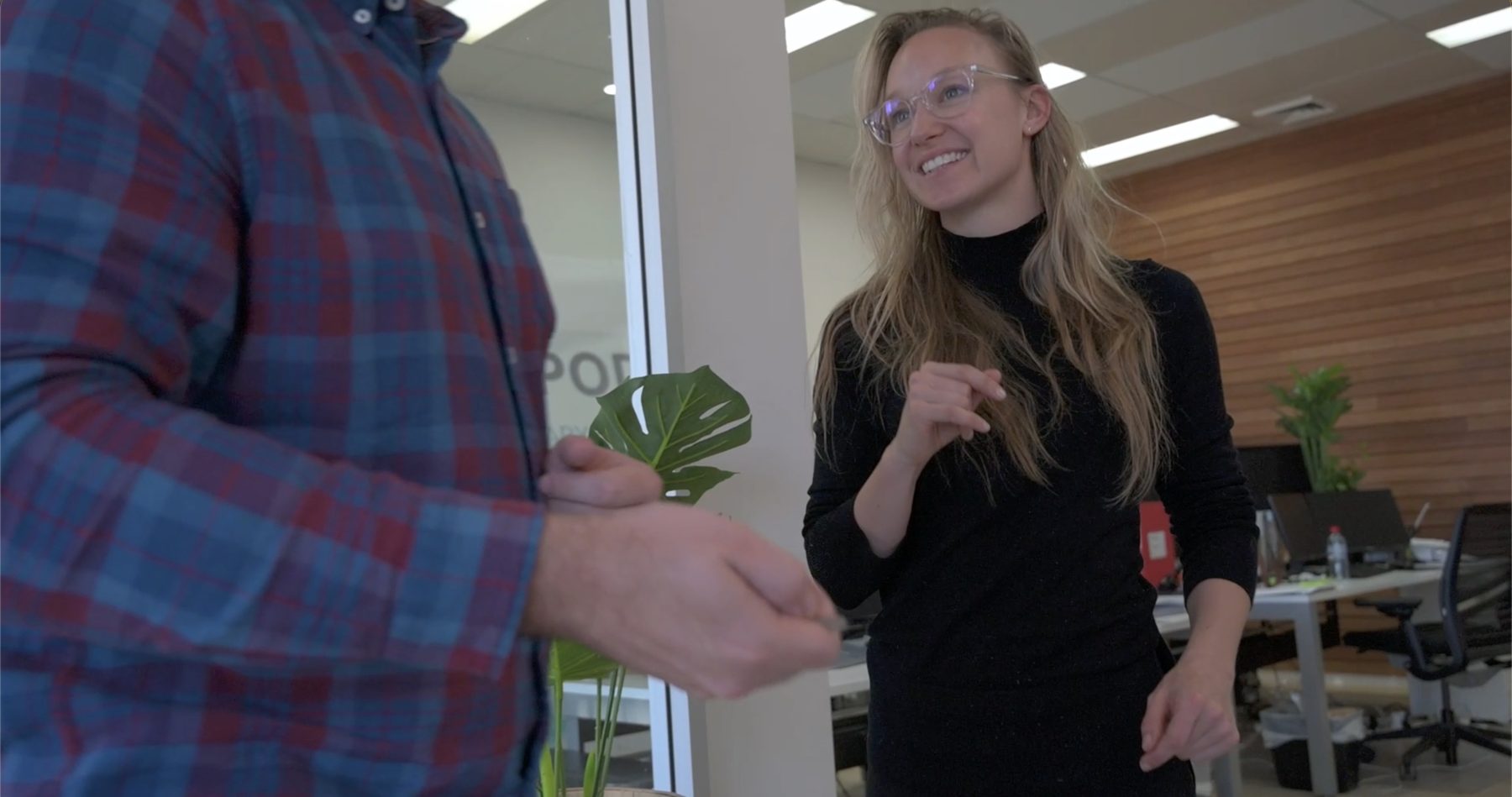 Jacqueline talking with a colleague in The Pod office
